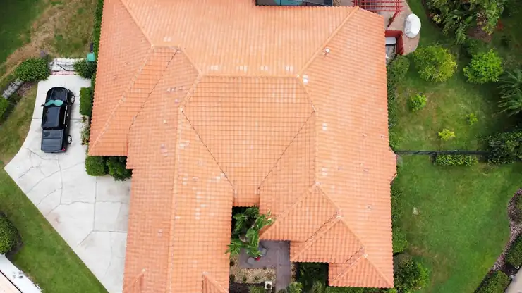 Aerial before and after of a tile roof soft wash in Orlando, Florida